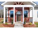 Inviting front porch with red siding, white trim, and decorative railing, enhancing the curb appeal of this lovely home at 1244 Bob Falls Rd, Shelby, NC 28150