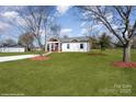 A beautiful house with well-maintained lawn and landscaping, set under a clear blue sky in a tranquil setting at 1244 Bob Falls Rd, Shelby, NC 28150