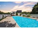 Inviting in-ground pool with gazebo and landscaping, perfect for outdoor relaxation and entertaining at 129 Renaissance Pl, Statesville, NC 28625