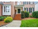 Inviting entrance with red brick steps, manicured landscaping, and classic architectural details at 138 Montibello Dr, Mooresville, NC 28117
