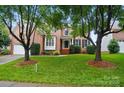 Charming brick home featuring manicured lawn and a classic facade with decorative shutters at 138 Montibello Dr, Mooresville, NC 28117