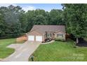 Picturesque property featuring lush greenery, a long driveway, and serene surroundings at 144 Sea Trail Dr, Mooresville, NC 28117