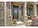 Inviting front porch with stone accents and a decorative front door at 14503 Crest Ct, Charlotte, NC 28278