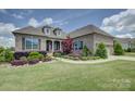 Well-manicured front yard with lush landscaping and a charming brick facade at 14503 Crest Ct, Charlotte, NC 28278