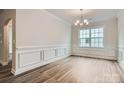 Formal dining room with wainscoting and hardwood floors at 1528 Croydon St, Indian Land, SC 29707