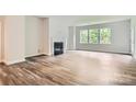 Bright living room featuring hardwood floors, fireplace, and abundant natural light at 1528 Croydon St, Indian Land, SC 29707