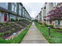 View of a row of townhouses with well-manicured lawns and inviting sidewalks at 1707 Cannon View Ln, Charlotte, NC 28208
