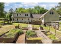 Spacious backyard featuring a large lawn and multiple garden beds, perfect for gardening enthusiasts at 1818 Winfield Dr, Monroe, NC 28110
