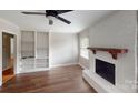 Bright living room with hardwood floors, fireplace, and built-in shelving at 2001 Lakeview Dr, Pineville, NC 28134