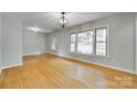 Bright and airy living room boasts large windows and gleaming hardwood floors at 2001 Lakeview Dr, Pineville, NC 28134