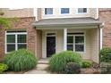 Close up of the entrance to a charming townhome with manicured landscaping at 206 Overstone Ct, Fort Mill, SC 29715