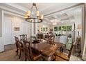 Open-concept dining area with coffered ceilings, modern chandelier, and seamless access to other living spaces at 2630 Mary Butler Way, Charlotte, NC 28226
