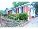 A cozy home displaying landscaped garden beds and a well-kept exterior and a paved driveway at 3016 Boston Ave, Charlotte, NC 28212