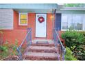 Close-up of the front entrance featuring a white door, brick steps, and decorative wreath at 3016 Boston Ave, Charlotte, NC 28212