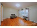 Bright living room with hardwood floors, a large window, and neutral wall color at 3016 Boston Ave, Charlotte, NC 28212