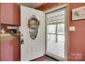 Welcoming front entrance featuring a white door with decorative glass and a cozy interior view at 3988 Old Hickory Rd, Lancaster, SC 29720