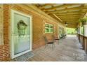 Inviting covered front porch with brick and wood accents, comfortable seating, and a welcoming entrance at 3988 Old Hickory Rd, Lancaster, SC 29720