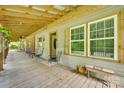 Inviting covered front porch with wood flooring, comfortable seating, and views of the surrounding landscape at 3988 Old Hickory Rd, Lancaster, SC 29720