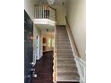 Entryway with a staircase leading to the second floor and hardwood floors throughout the downstairs at 4504 Bellmore Ct, Charlotte, NC 28269