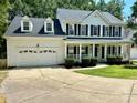 Beautiful two-story home with black shutters, a white porch, and a well-maintained lawn at 4504 Bellmore Ct, Charlotte, NC 28269