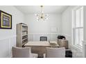 Well-lit home office with neutral tones, featuring a desk, shelving, and a motivational 