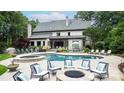 An outdoor oasis with a beautiful pool, hot tub, fire pit, and comfortable seating at 5523 Meadow Haven Ln, Charlotte, NC 28270