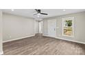 Bright living room featuring vinyl floors, a ceiling fan, and natural light streaming through the windows at 626 W Bell St, Statesville, NC 28677