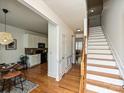 Welcoming entryway boasts hardwood floors, stairs to the upper level, and entry to the kitchen and living areas at 6505 Central Pacific Ave, Charlotte, NC 28210