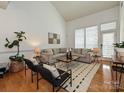 Bright living room features high ceilings, large windows, comfortable seating, and stylish decor at 6505 Central Pacific Ave, Charlotte, NC 28210