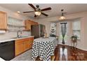 Bright kitchen featuring stainless steel appliances, wooden cabinets, hardwood floors and an island at 7007 Broad Leaf Ct, Indian Trail, NC 28079