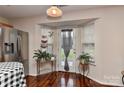 Bright kitchen with stainless steel appliances, hardwood floors, and a bay window with outdoor view at 7007 Broad Leaf Ct, Indian Trail, NC 28079