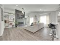 Open-concept living room featuring wood floors, fireplace, built-in shelving, and abundant natural light at 7442 Crestside Ln, Charlotte, NC 28227