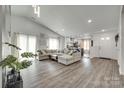 Spacious living room with hardwood floors and natural lighting, seamlessly connecting to the kitchen area at 7442 Crestside Ln, Charlotte, NC 28227