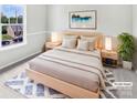 Staged bedroom featuring a serene aesthetic, soft lighting, and a comfortable king-sized bed at 752 Raindrops Rd, Gastonia, NC 28054