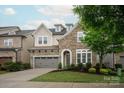 Charming stone and siding two-story home with a two-car garage and well-manicured lawn at 7913 Waverly Walk Ave, Charlotte, NC 28277