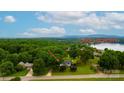 Expansive view of the lake house featuring lush greenery and a glimpse of Lake Hickory at 827 River Hills Ct, Taylorsville, NC 28681