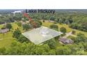 Lake Hickory home with a beautiful lot, surrounded by trees and a view of the lake at 827 River Hills Ct, Taylorsville, NC 28681
