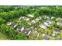 An aerial view of a neighborhood of single Gathering homes interspersed with lush green trees at 9530 Hightower Oak St, Huntersville, NC 28078