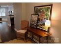 A welcoming entryway showcasing decor, hardwood floors, and a glimpse into the living area at 1000 E Woodlawn Rd # 107, Charlotte, NC 28209