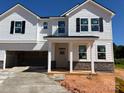 Charming two-story home with a covered porch, garage and black window shutters at 1005 Cunningham Farm Dr, Indian Trail, NC 28079