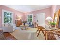 Cozy living room featuring light pink walls, natural light, and hardwood floors at 1120 N College St, Mount Pleasant, NC 28124
