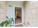 Inviting entrance with red door, view of foyer with stairs, and tile flooring at 1162 E 36Th St, Charlotte, NC 28205