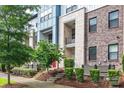 Modern multi-story townhome featuring brick and stone facade, balconies, and manicured landscaping at 1162 E 36Th St, Charlotte, NC 28205