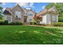 Charming home with a stone and siding facade, lush green lawn, and well-manicured landscaping at 129 Alder Springs Ln, Mooresville, NC 28117