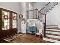 Elegant foyer with hardwood floors, staircase with iron railing, and stylish decor at 129 Alder Springs Ln, Mooresville, NC 28117