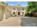 Elegant home with a brick driveway, a three-car garage, and a basketball hoop at 14515 Nolen Ln, Charlotte, NC 28277