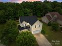 Aerial view of a two-story home with an attached garage amid lush green trees at 1534 Piney Church Rd, Concord, NC 28025