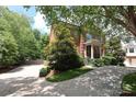 A beautiful two-story brick home shows off a manicured yard and a convenient parking area at 1638 Myers Park Dr, Charlotte, NC 28207
