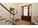 Inviting foyer with hardwood floors, a striking staircase, and a beautifully crafted front door at 1638 Myers Park Dr, Charlotte, NC 28207