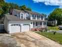 Traditional home boasting a three-car garage and welcoming front porch, perfect for relaxing at 2008 Bantry Ln, Charlotte, NC 28262